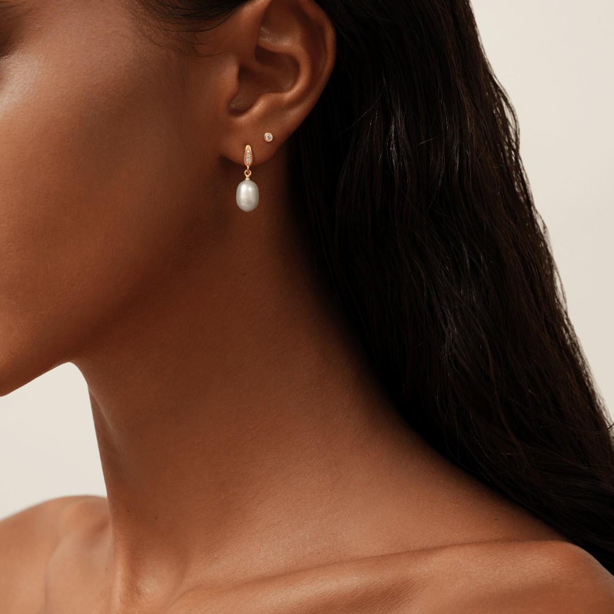 Model bærer Ocean Earrings med ferskvandsperle, samt en ekstra lille creol i samme øre